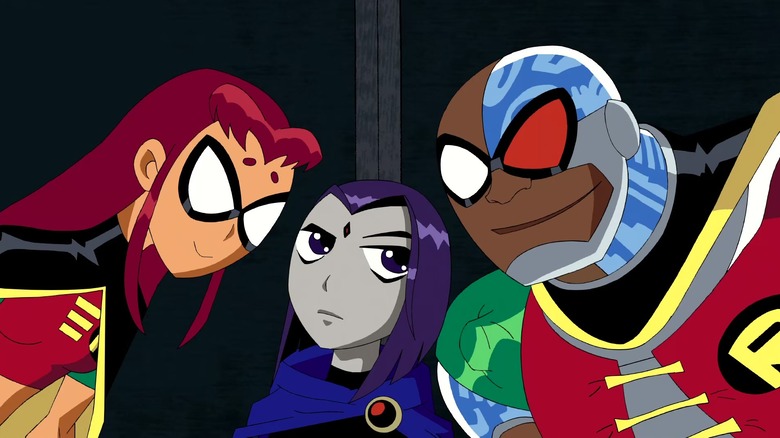 Starfire and Cyborg loom over Raven