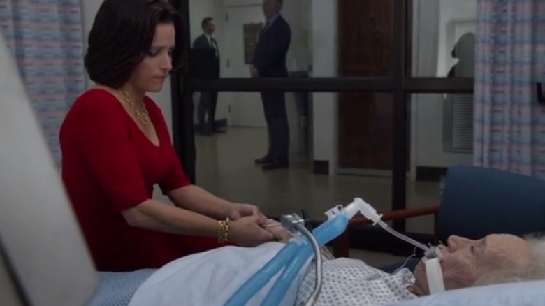 Selina sits by her mother's hospital bed