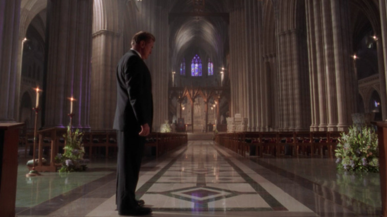 Bartlet standing in empthy cathedral 