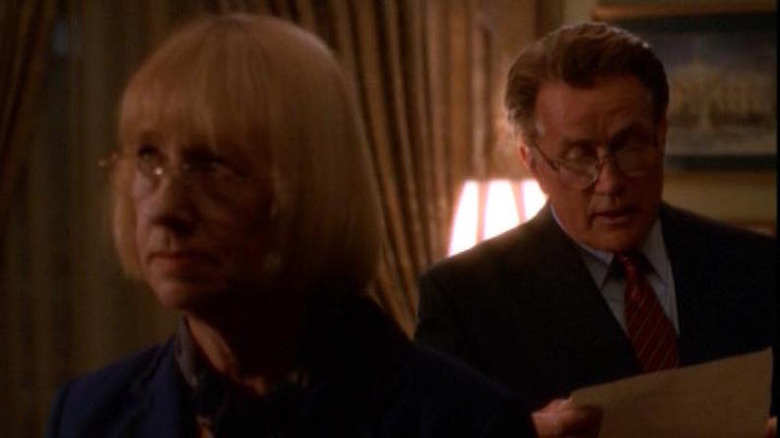 Mrs. Landingham standing in front of Bartlet 