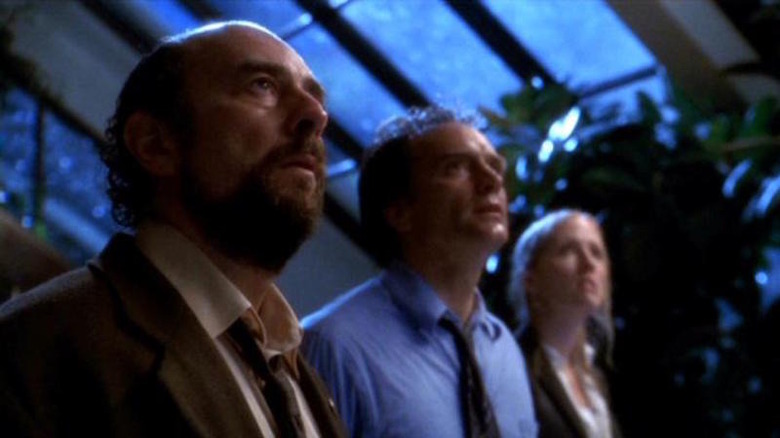 Toby, Josh, and Donna standing inside a greenhouse