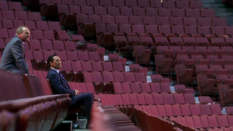 Leo and Santos sitting in empty auditorium 