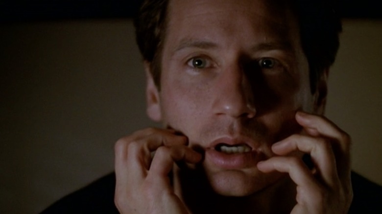 David Duchovny hands on face