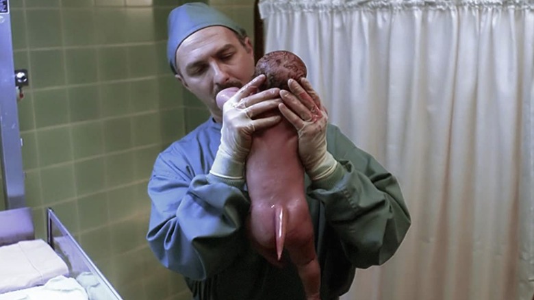 doctor holding baby with tail