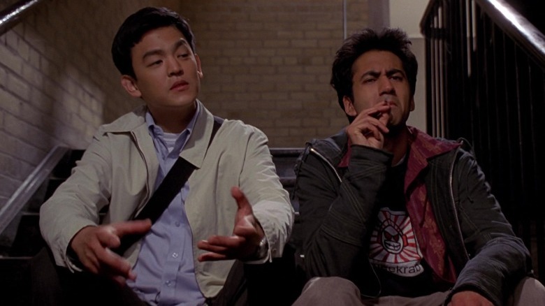 Harold and Kumar sitting on step