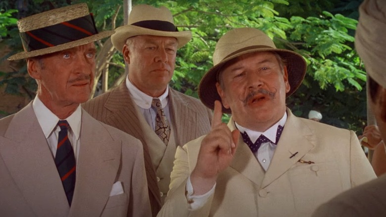 Poirot standing and pointing