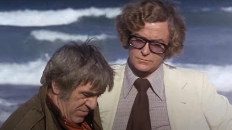 Michael Caine talks to suspect on the beach