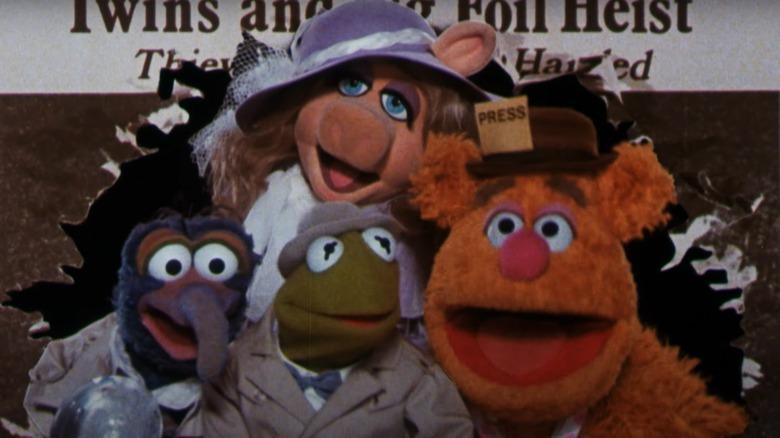 The Muppets burst out of a newspaper