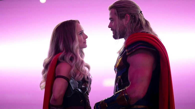 Natalie Portman and Chris Hemsworth look at each other