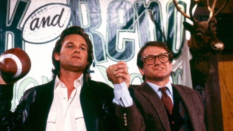 Kurt Russell holds hands with Robin Williams