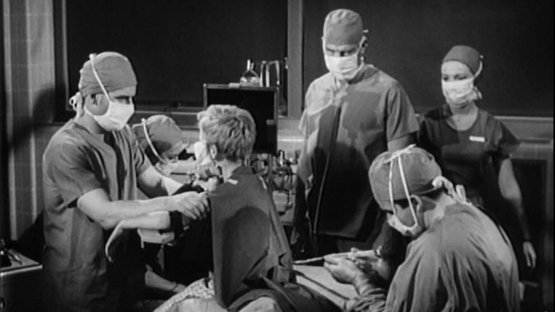 A group of surgeons look after a patient