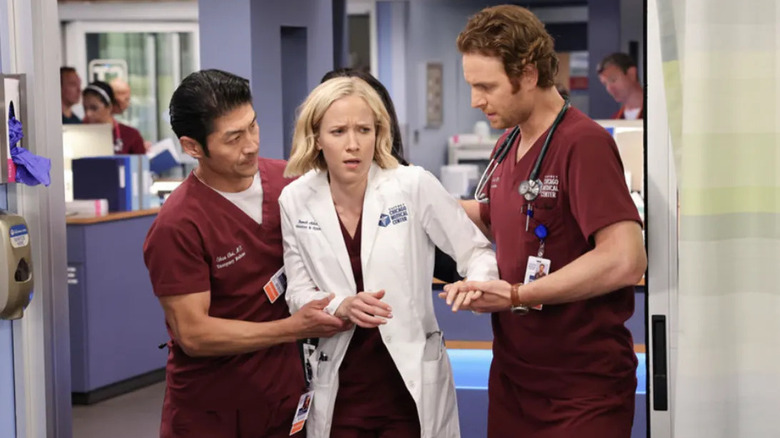 Gehlfuss and Tee help a surgeon walk through doors