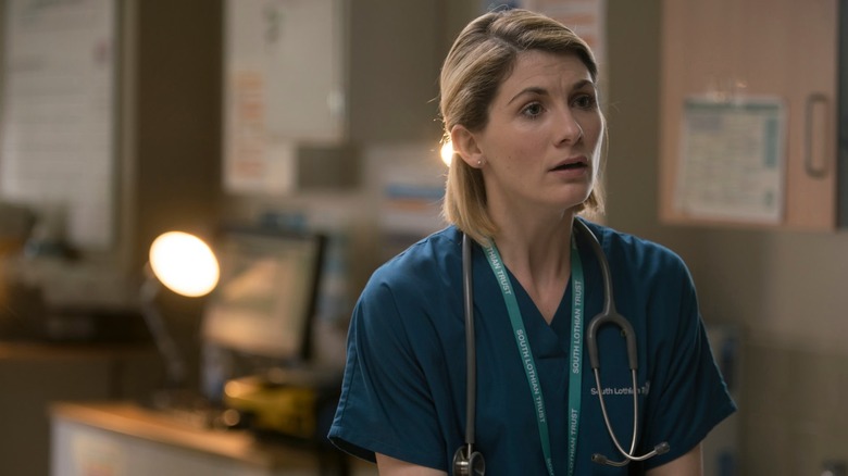 Jodie Whittaker sits on a desk