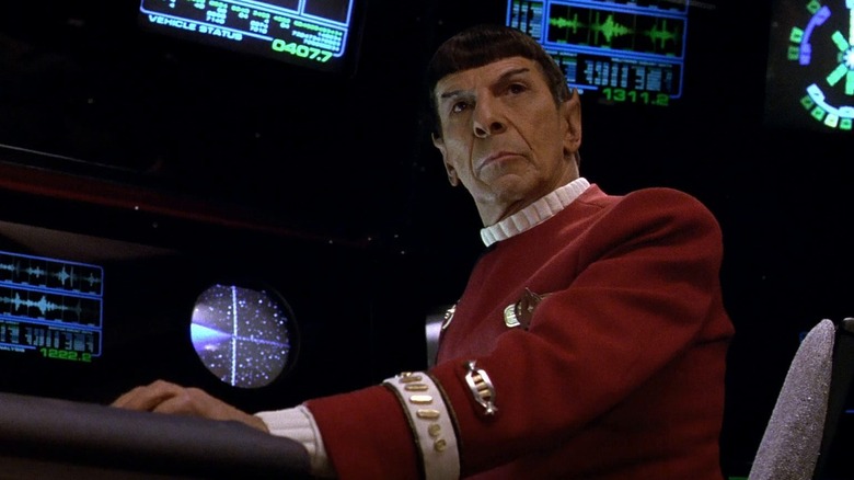 Spock at a computer console on the bridge