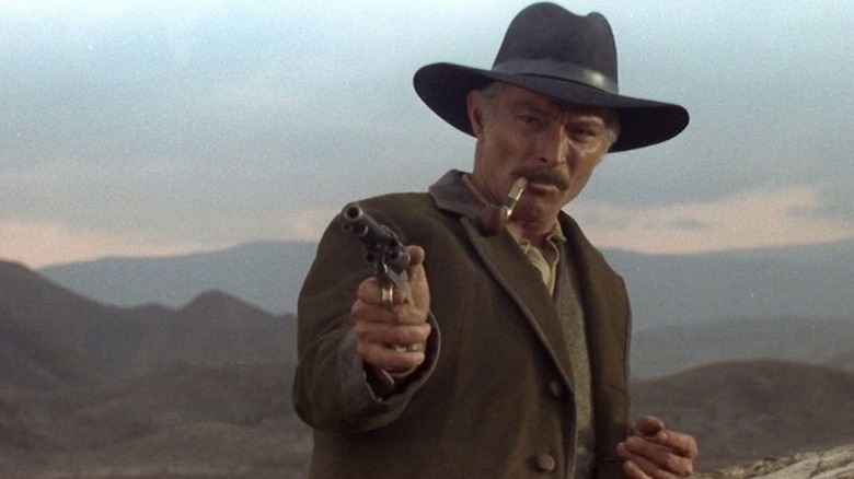 Van Cleef aims his pistol