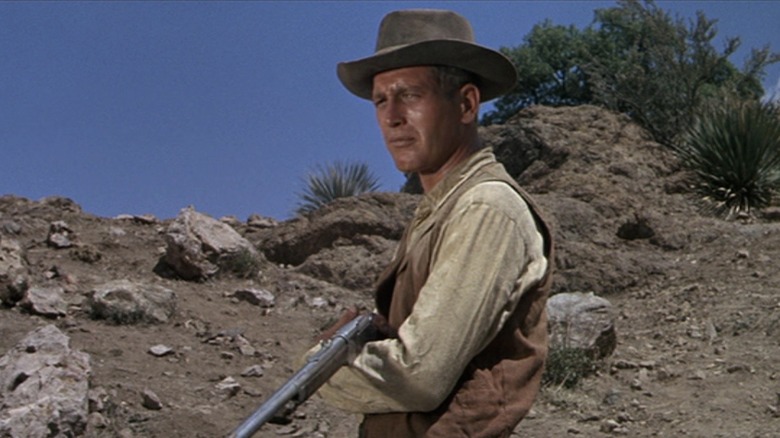 Newman holds his rifle