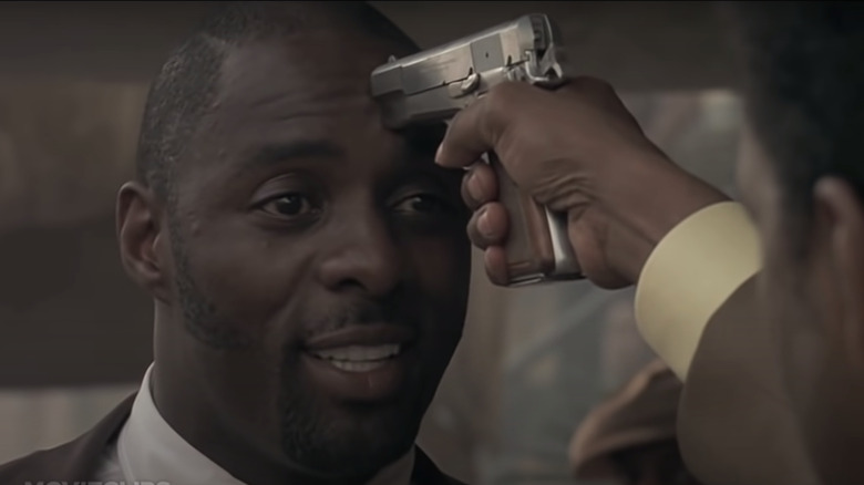 Idris Elba with gun to head