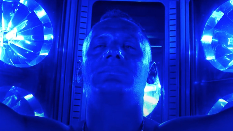 Man in blue tanning booth