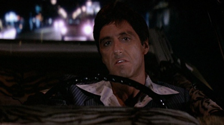 Tony Montana sneering in car Scarface 1983