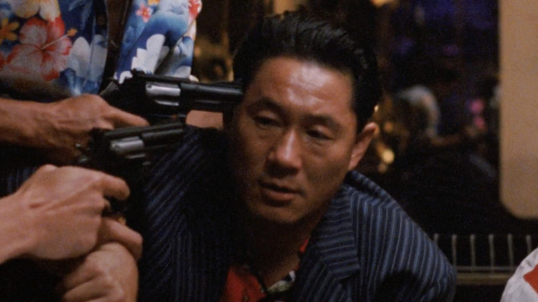 Takeshi Kitano with two guns to head