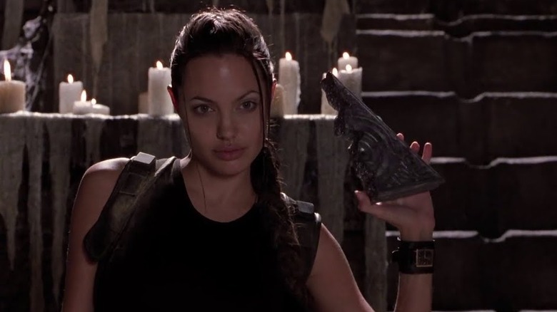 Lara Croft holding up an artifact 