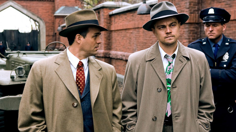 Ruffalo and DiCaprio standing in coats and hats