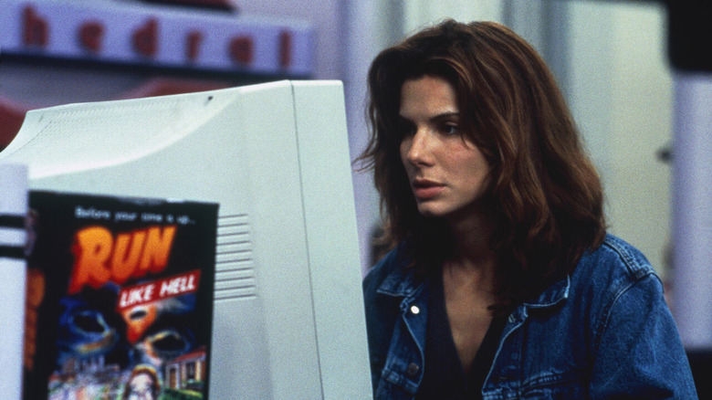 Bullock looking at desktop computer 