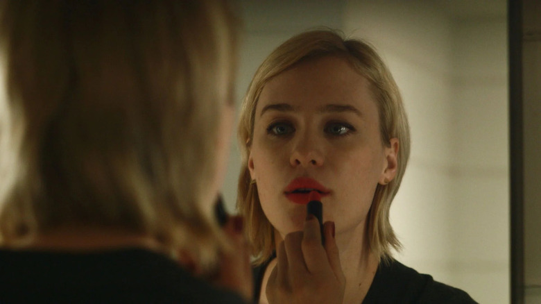 Mackenzie Davis puts on lipstick