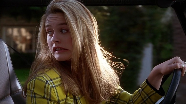 Cher Horowitz winces while driving
