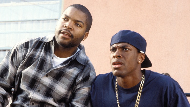 Ice Cube and shocked Chris Tucker look off to side