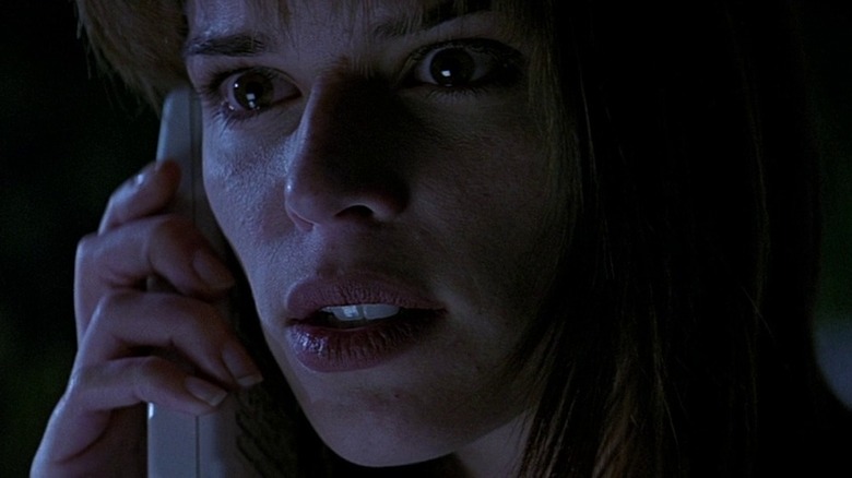 Scared Sidney Prescott holds up phone