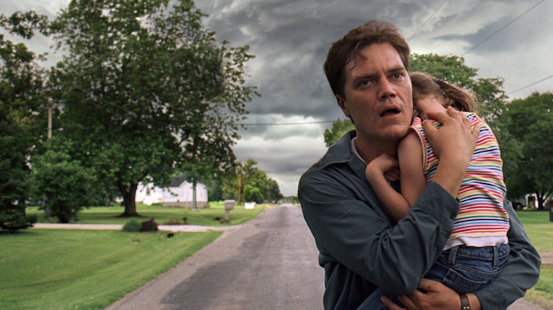 Curtis holding Hannah fleeing storm