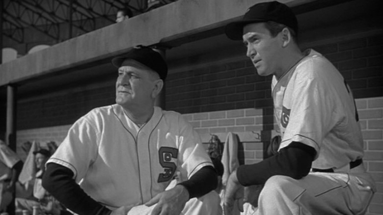 Jimmy Stewart stands in the dugout