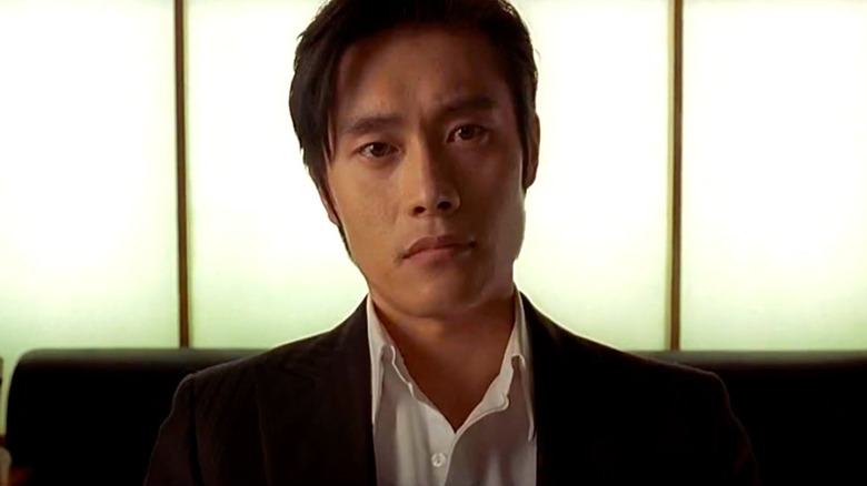 Lee Byung-hun staring at camera