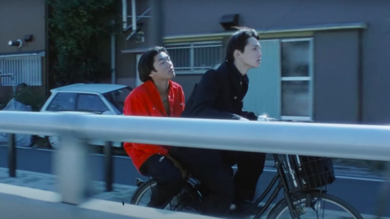 Ken Kaneko and Masanobu Ando riding bike