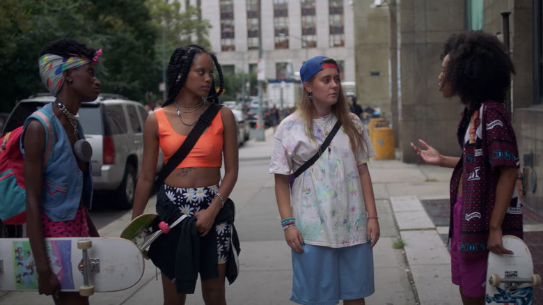 Betty skateboarders on city street