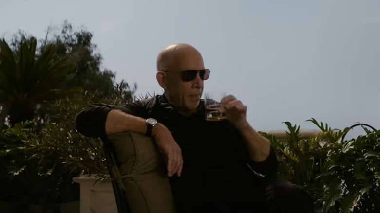 J.K. Simmons sipping drink outdoors