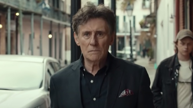 Gabriel Byrne wearing black suit