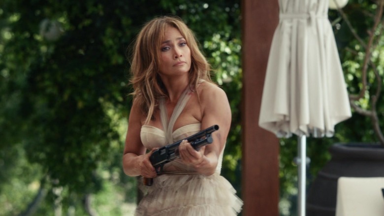 Jennifer Lopez points a shotgun