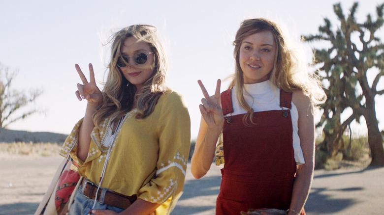 Aubrey Plaza and Elizabeth Olsen give peace sign