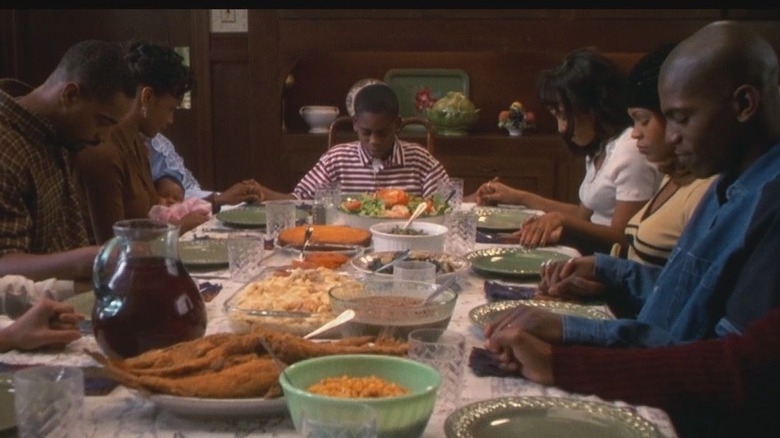 Family praying before dinner