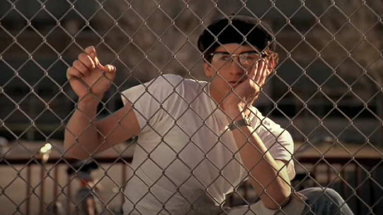 Patrick Dempsey behind chain-link fence