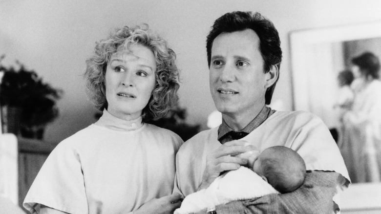 Glenn Close and James Woods hold baby