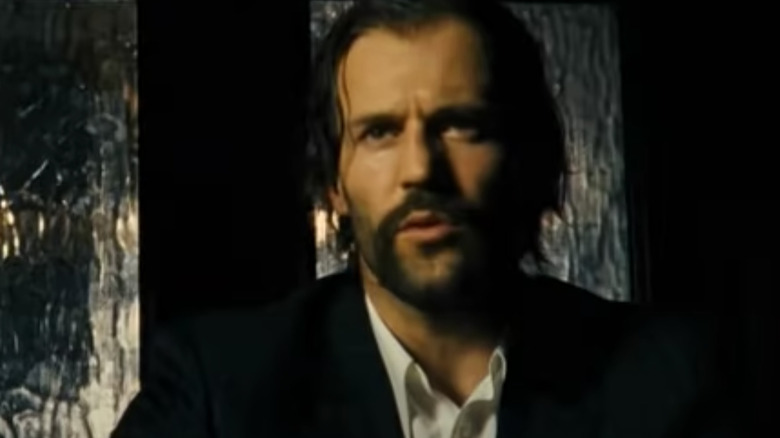 Jason Statham with long hair and mustache