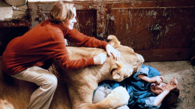 Madeleine trying to wrestle a lion off Melanie in Roar (1981)