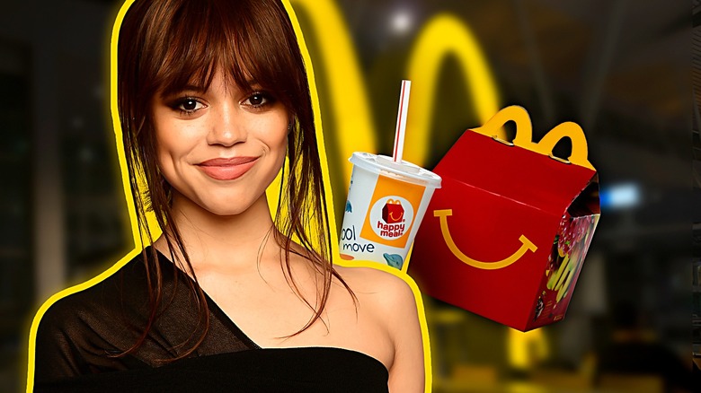Jenna Ortega smiling next to McDonalds happy meal