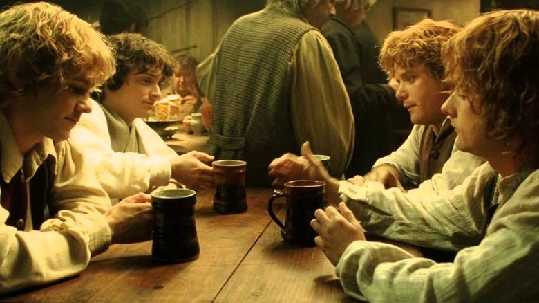 Four hobbits drink beer