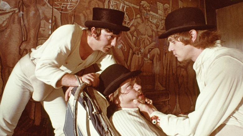 Droogs torturing a man