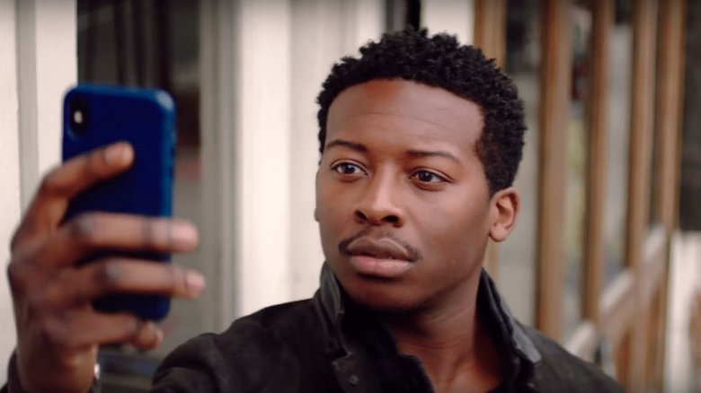 Miles looking at his phone