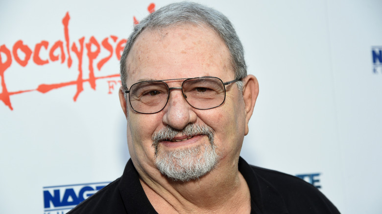 John Milius smiling